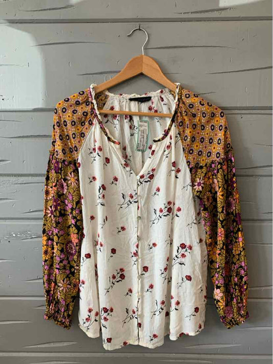White V-neck blouse with red floral print and contrasting orange floral long sleeves in size large.
