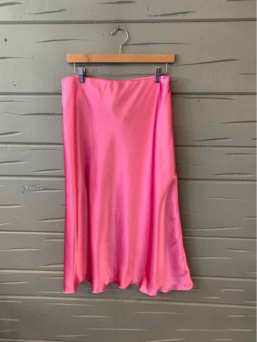 Pink satin midi skirt with slight flare and smooth finish hanging on wooden hanger.