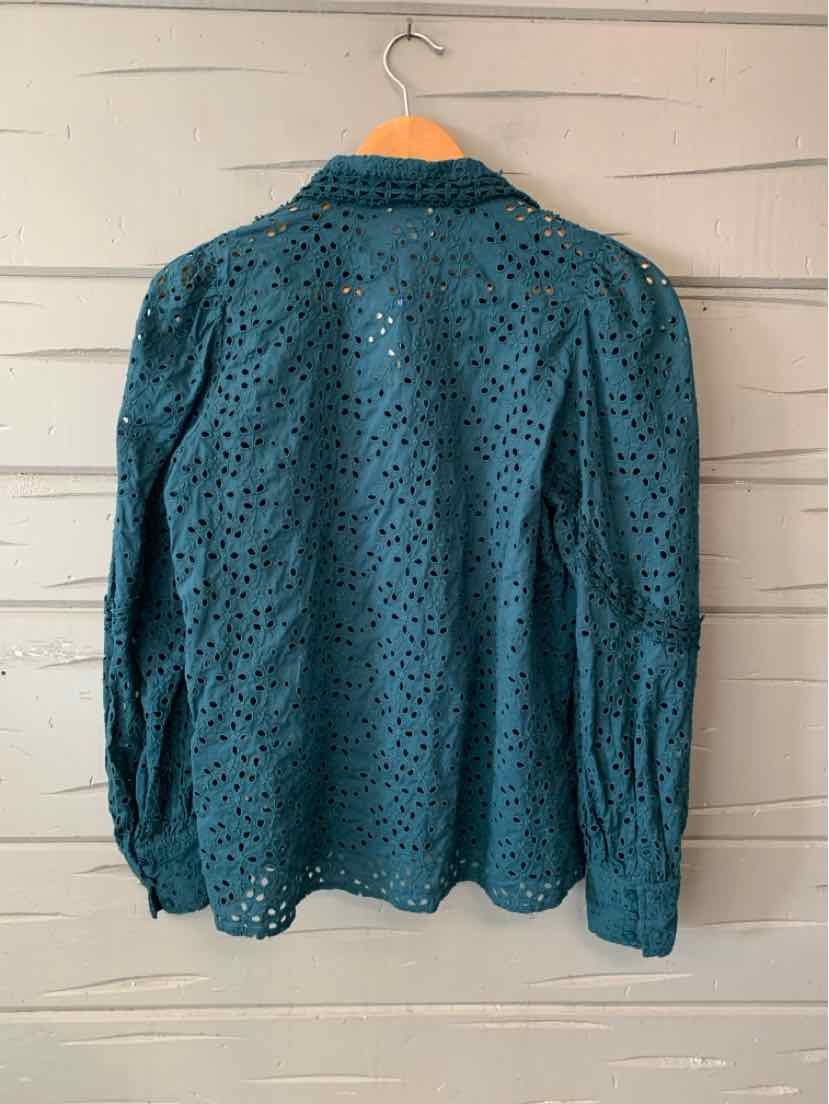 Teal long-sleeve blouse with a small dark dotted pattern, collared neckline, and button front.