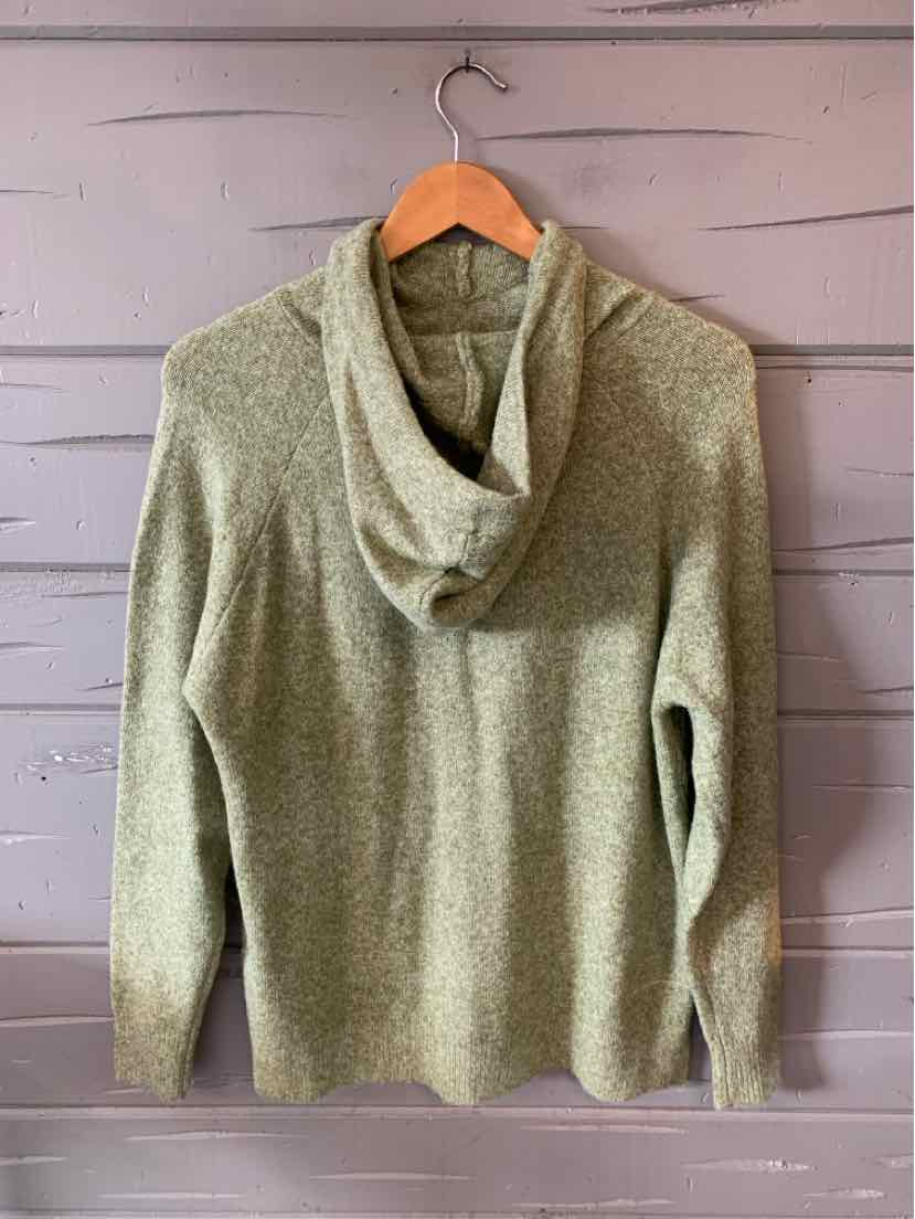 Light green knitted hoodie with long sleeves and a textured fabric hanging on wooden hanger.