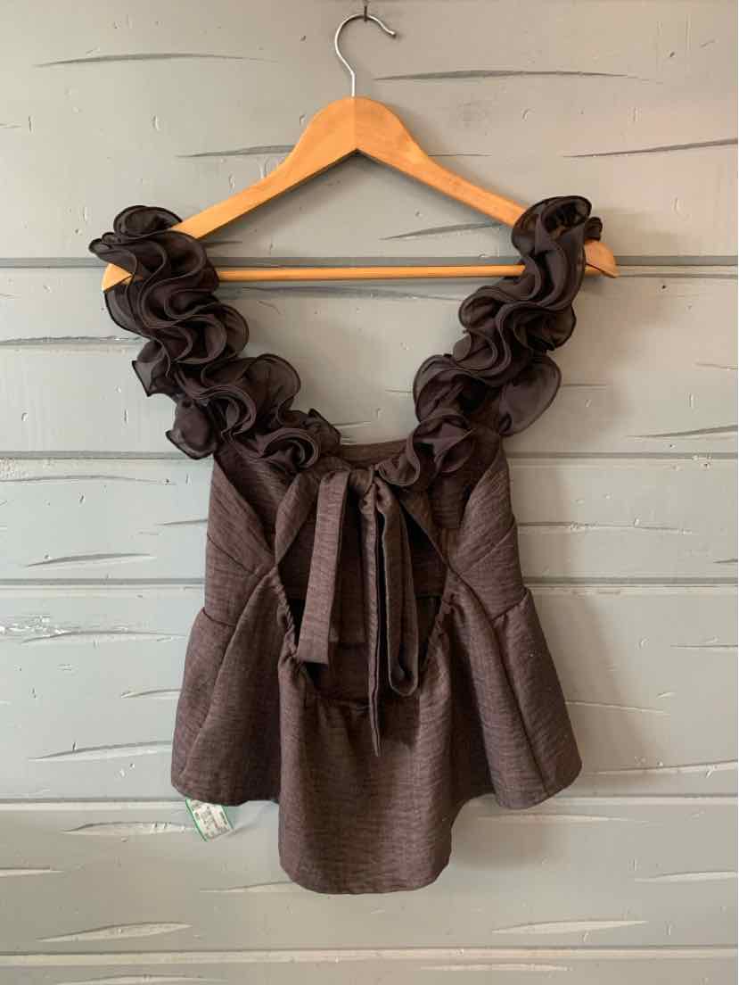 Brown sleeveless top with ruffled straps and a tie waist detail, textured fabric.