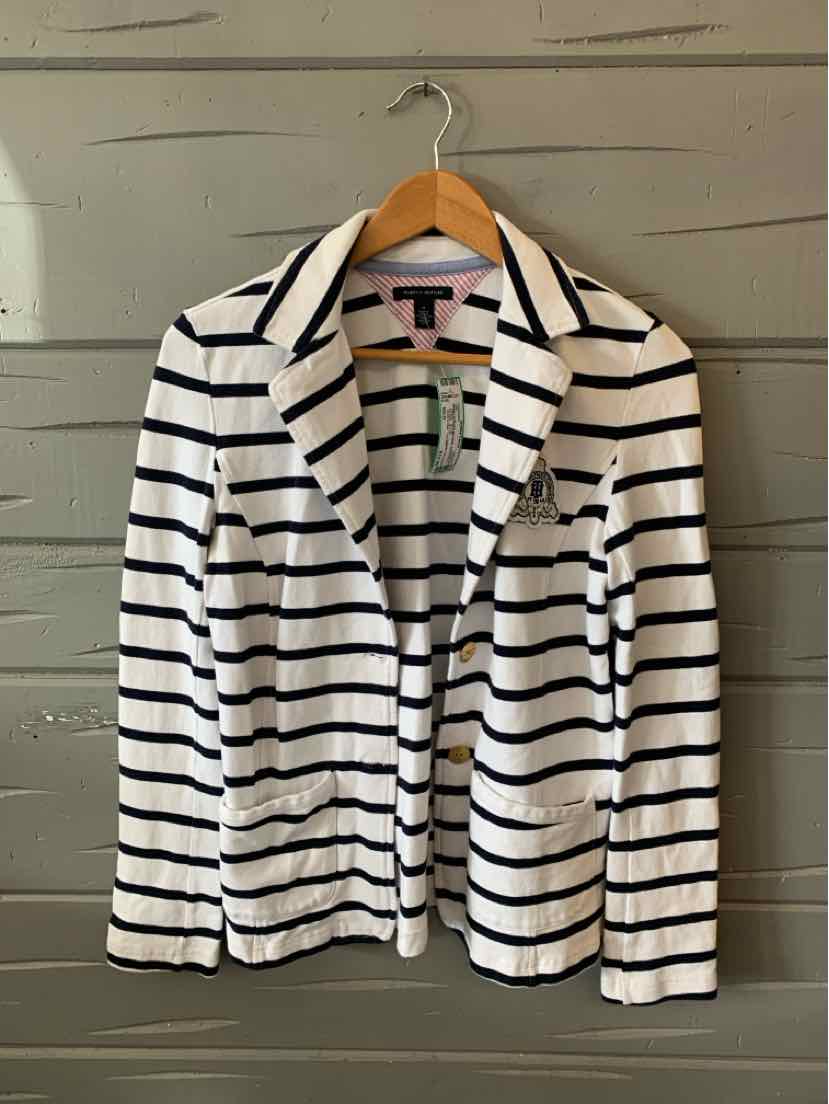 White blazer with black horizontal stripes and notched lapel collar on wooden hanger.