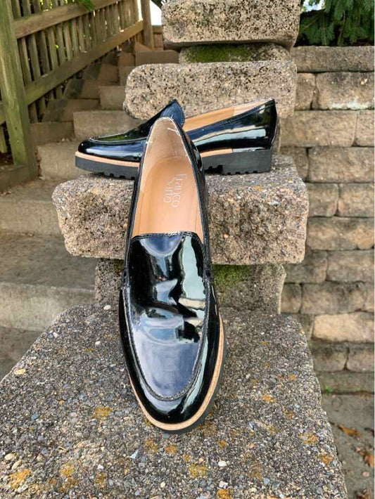 Black patent leather women's loafer with beige sole, perfect for casual tops and denim jeans.