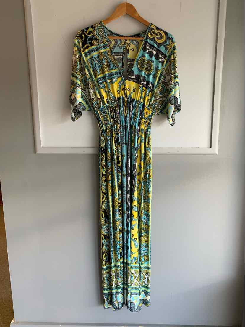 Long multicolor paisley dress with cinched waist and elbow-length sleeves on wooden hanger.