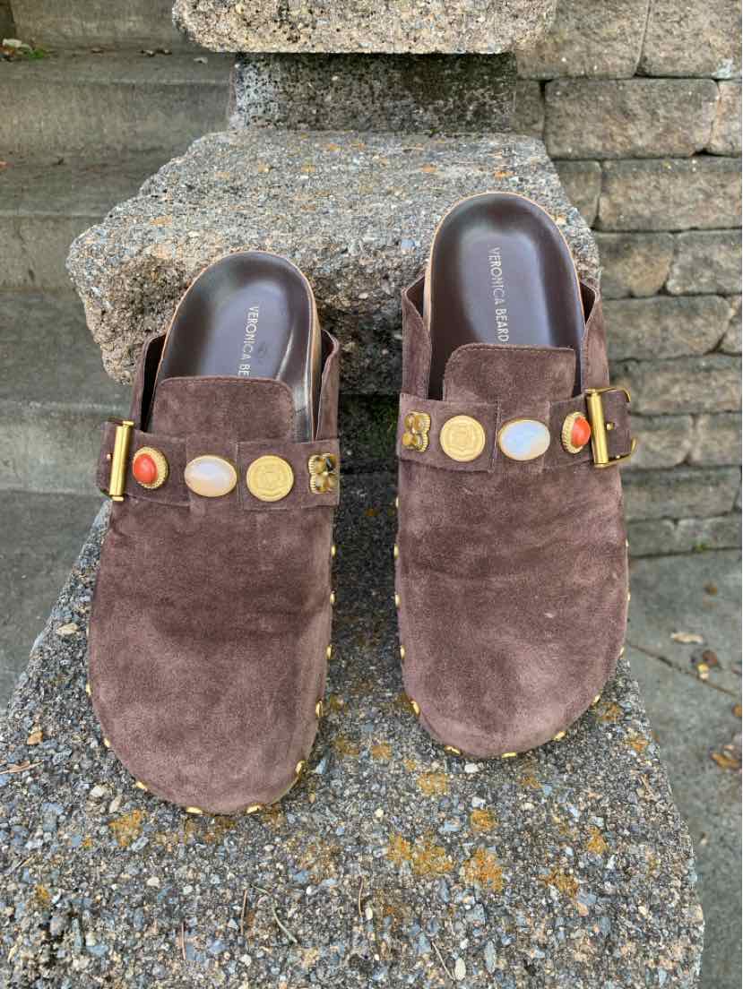 Women's brown suede backless clogs with dark leather insoles and gold-tone studs across the uppers.