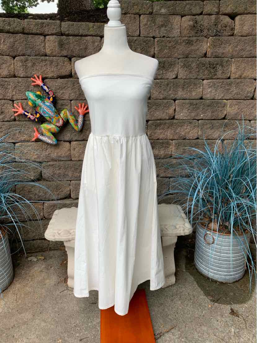 White strapless midi dress with elasticized waist and flowy skirt on mannequin.