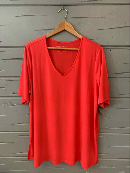 Red short-sleeve V-neck blouse in size 1X with a relaxed fit on wooden hanger.