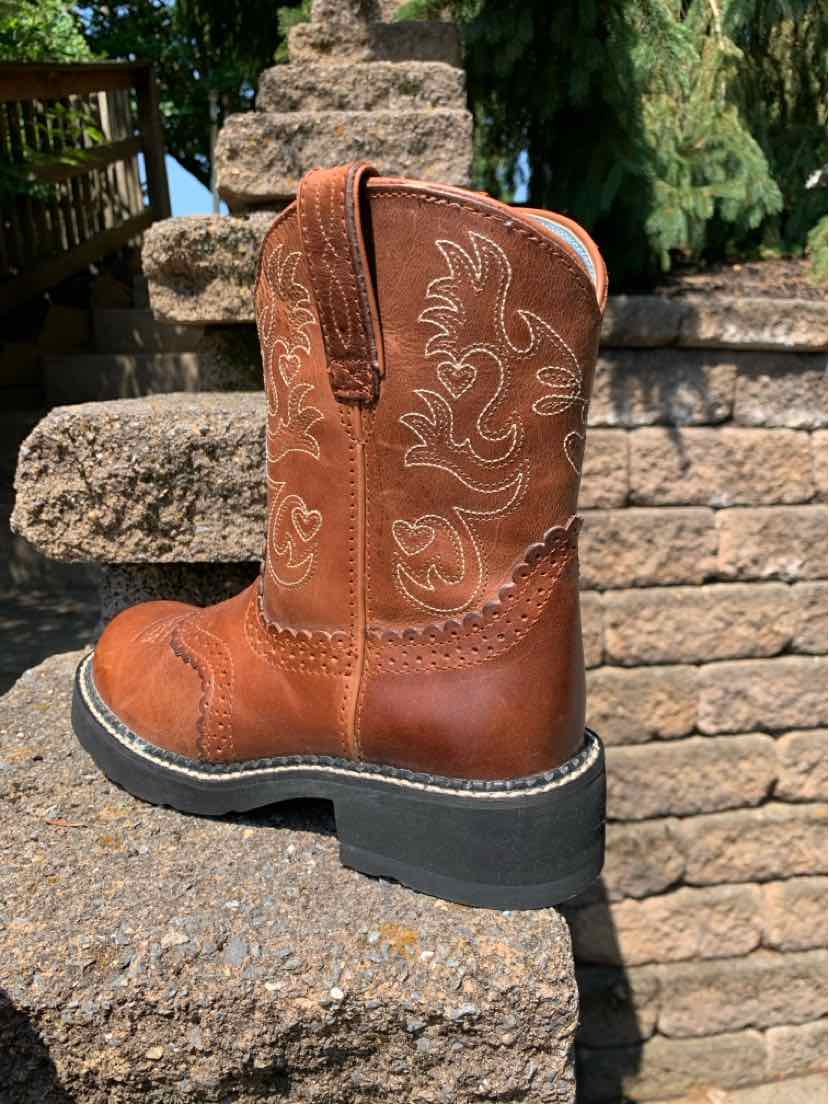 Brown leather western boot with intricate stitched floral designs, rounded toe, and sturdy black sole.