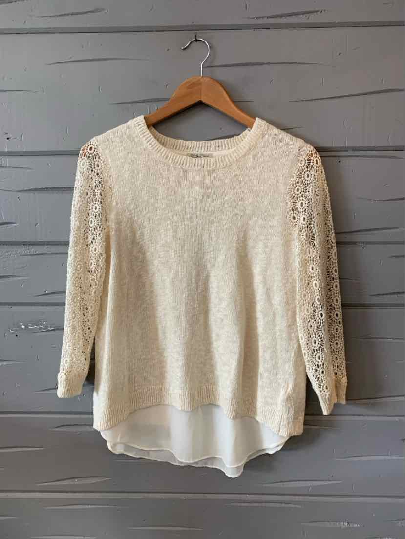 Cream long-sleeve lace top with layered hem and round neck, medium size.
