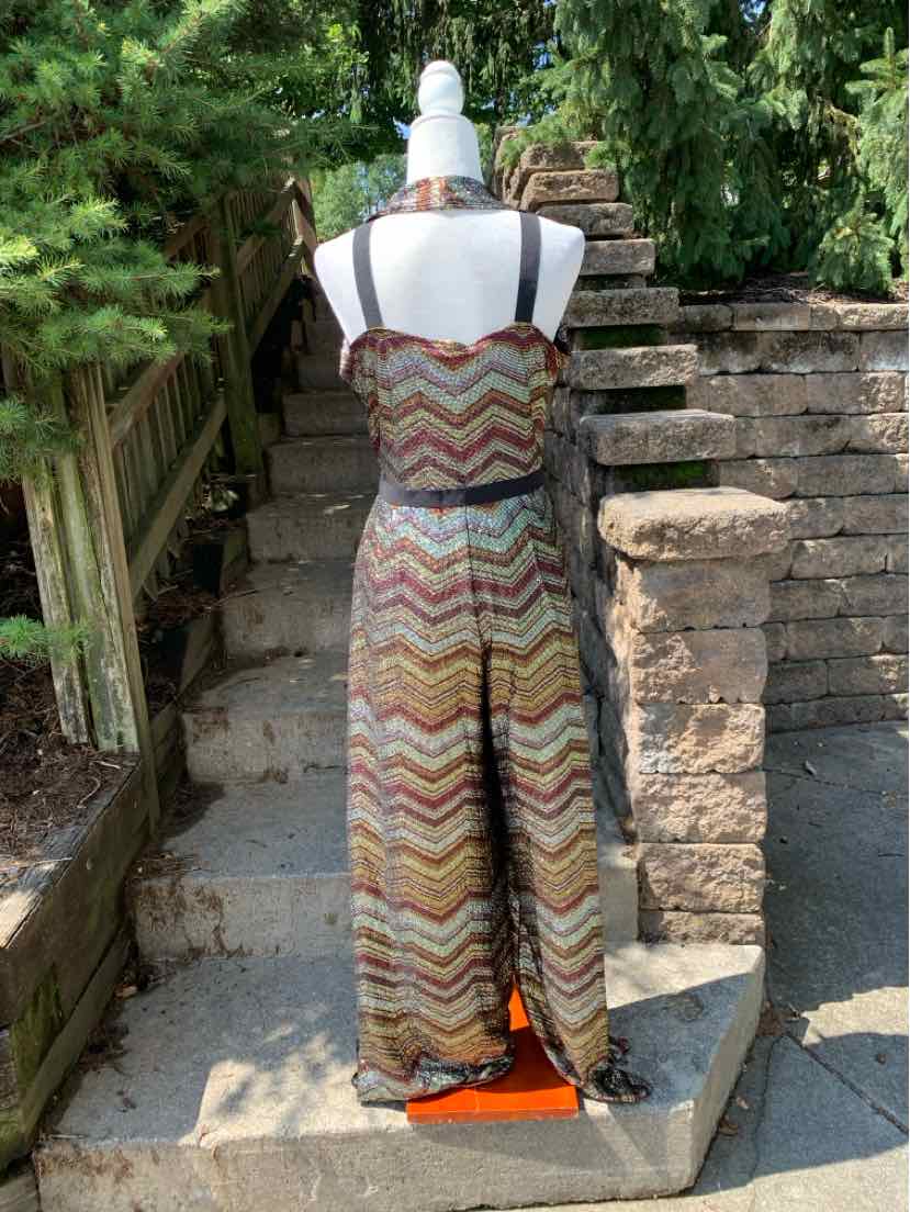 Women's sleeveless jumpsuit with multicolor zigzag pattern and wide-leg pants.