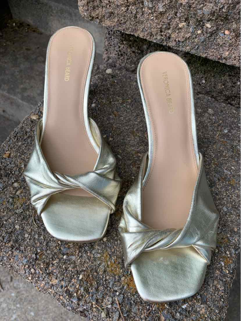 Metallic gold slip-on sandals with twisted strap detail and square toe, size 8.5.