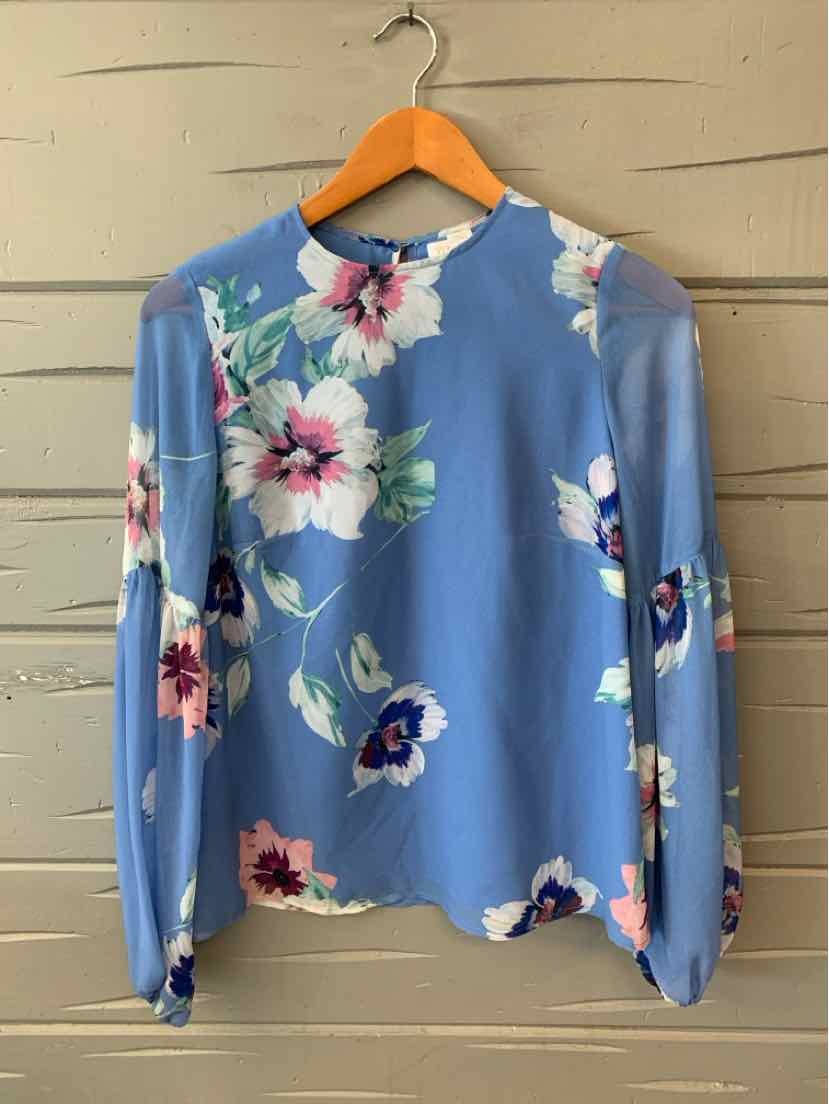 Blue blouse with pink and white floral print, long puff sleeves, crew neckline, and lightweight fabric.