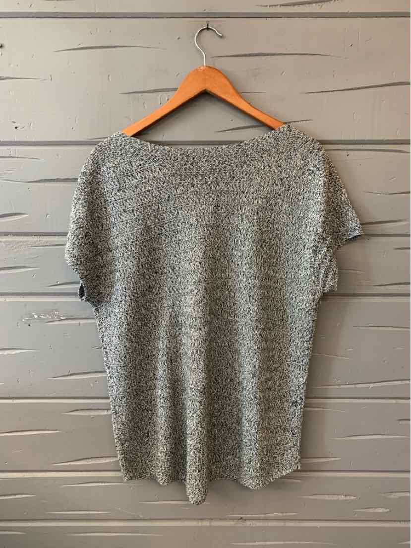 Light gray short-sleeve knit top with a round neckline, loose fit, hanging on wooden hanger.