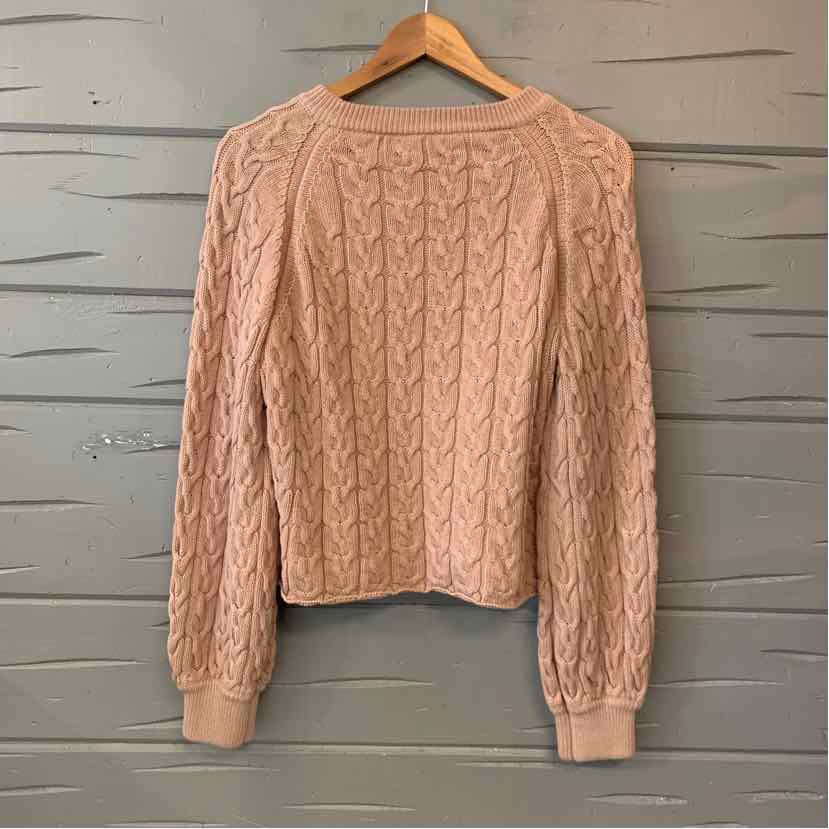 Tan cable-knit sweater with a crew neck, long sleeves, and ribbed cuffs and hem.