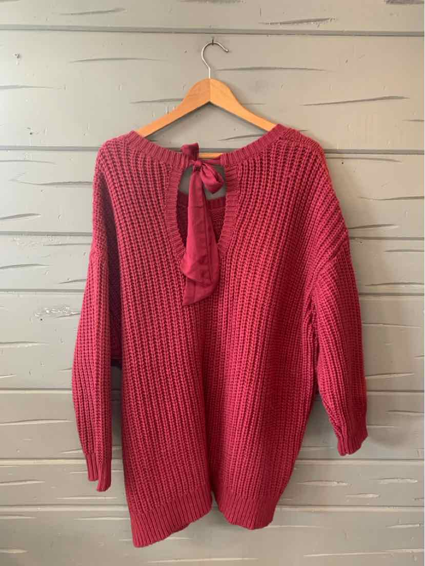 Deep burgundy knit sweater with ribbed texture and long sleeves, featuring a back tie detail at the neckline.