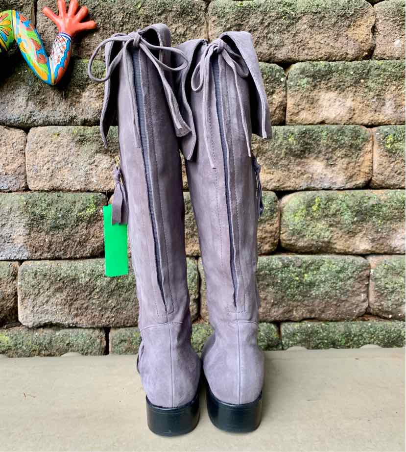 Tall gray suede boots with black soles, lace-up detail at the back, size 38.