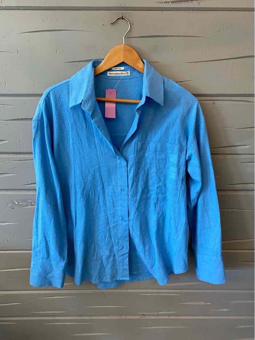 Light blue long-sleeve button-up shirt with collar, made from soft fabric, size XS.