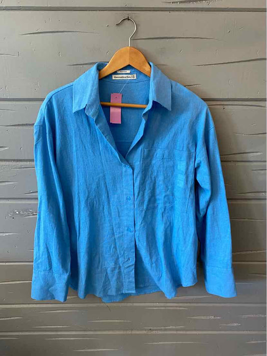 Light blue long-sleeve button-up shirt with collar, made from soft fabric, size XS.