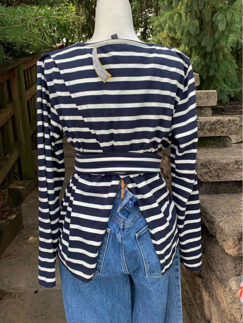 Navy blue and white striped long-sleeve top with open back and adjustable tie detail at waist.