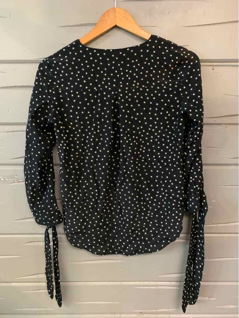 Black long-sleeve blouse with white star print, round neckline, and tie details at cuffs.