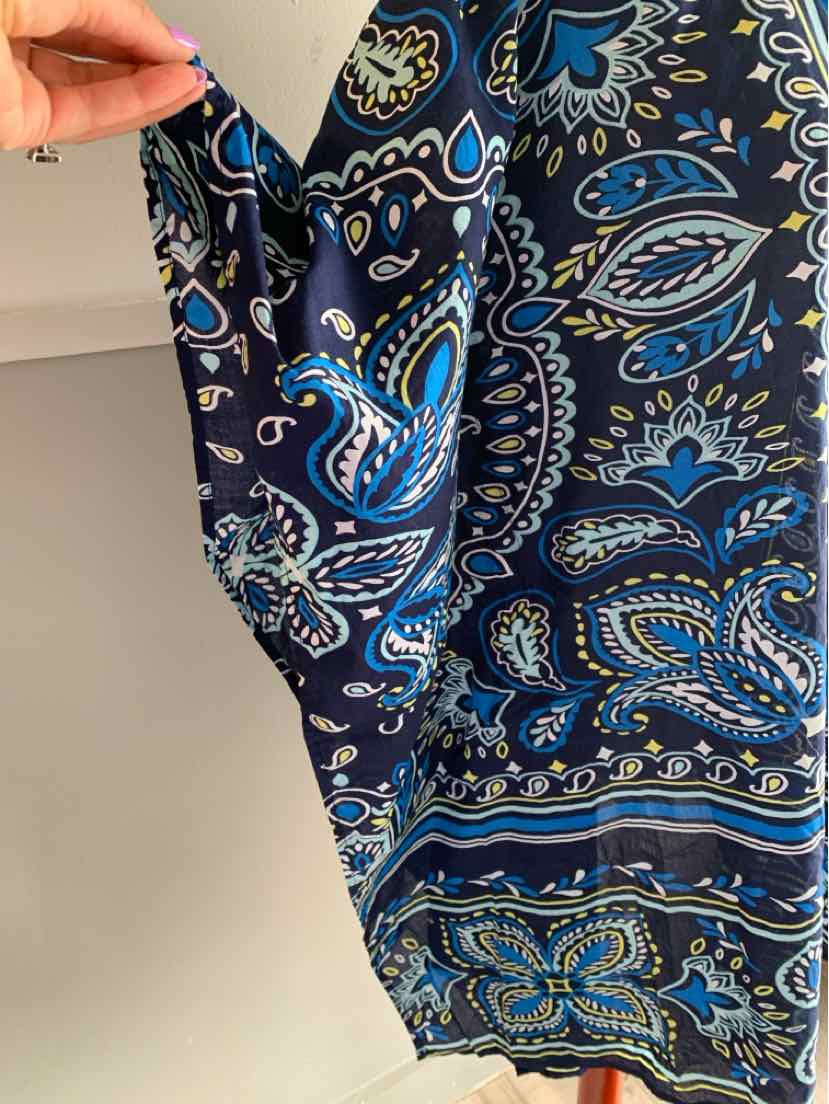 Navy blue paisley patterned fabric with shades of blue and cream, held by hand showing soft texture.