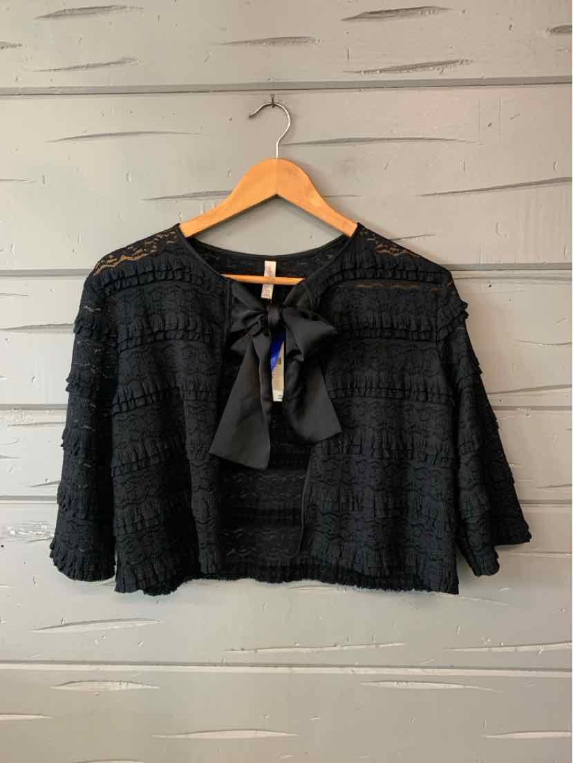 Black lace Lyrebird blouse with a sheer scalloped yoke, flared sleeves, and a necktie bow.