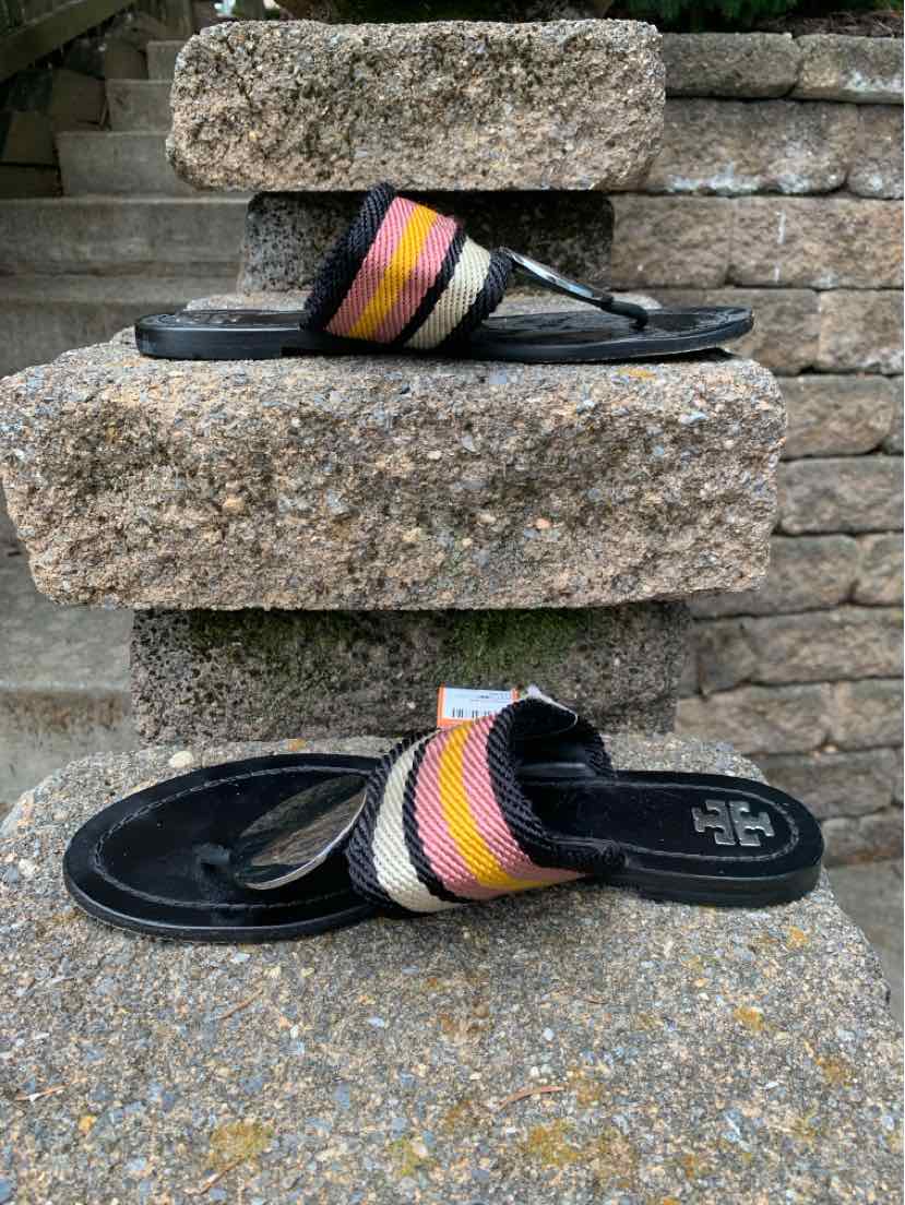 Black flat sandal with woven multicolor striped strap and cushioned footbed, size 8.