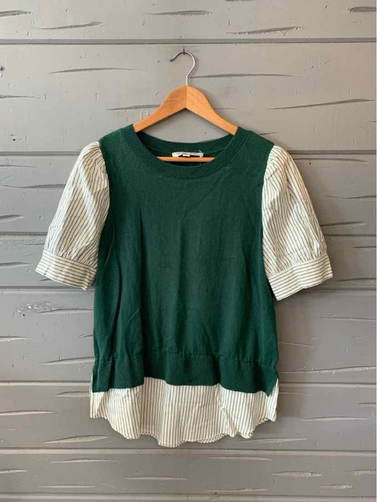 Green knit top with short, puffed white sleeves and a white hem detail.
