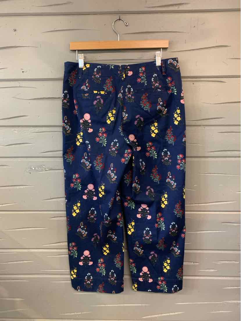 Navy blue cropped pants with multicolored floral pattern and front pockets.