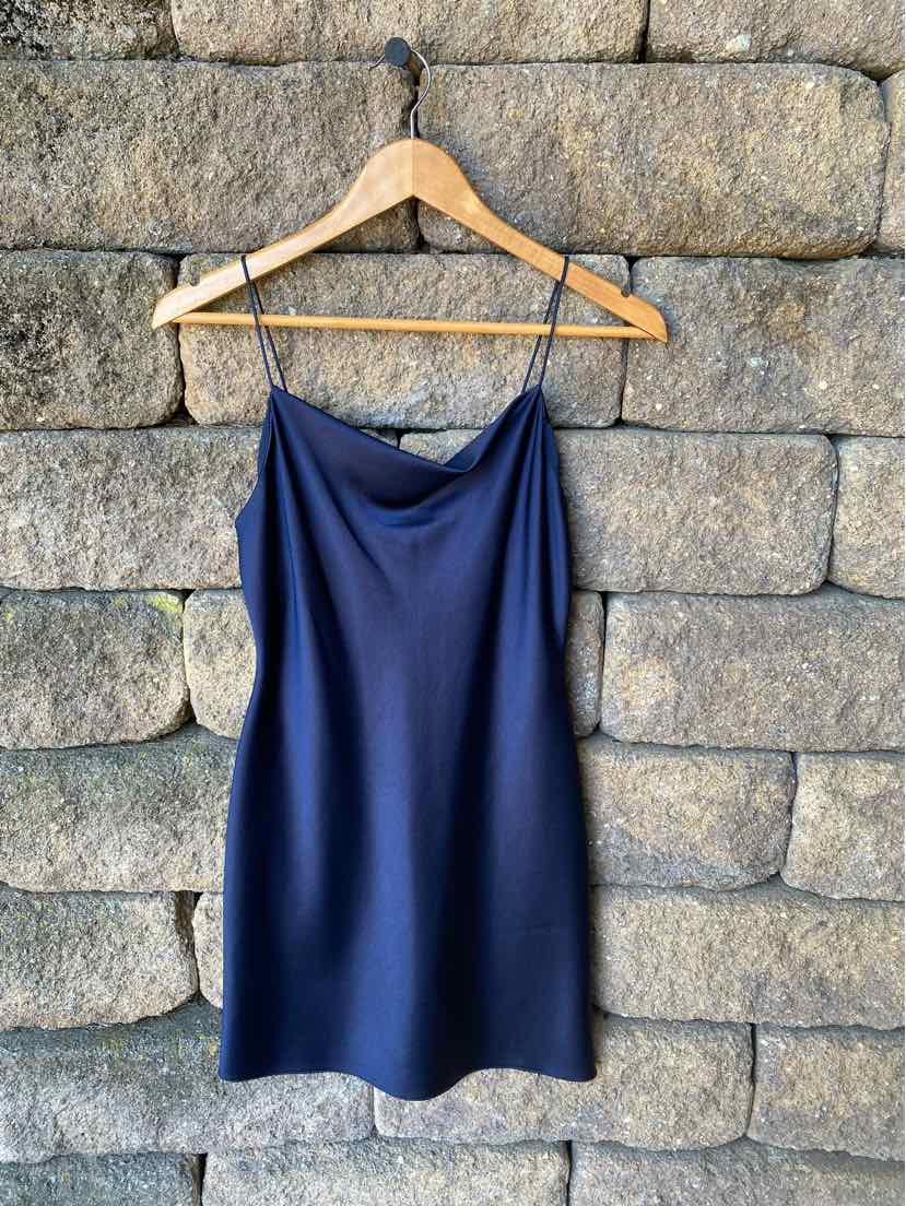 Navy blue satin slip dress with thin spaghetti straps and a straight neckline.