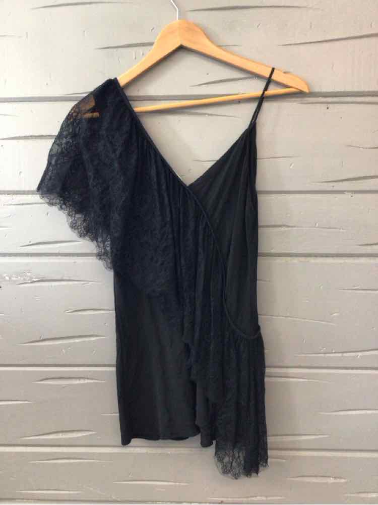 Black asymmetric dress with lace detailing and thin spaghetti strap on hanger.