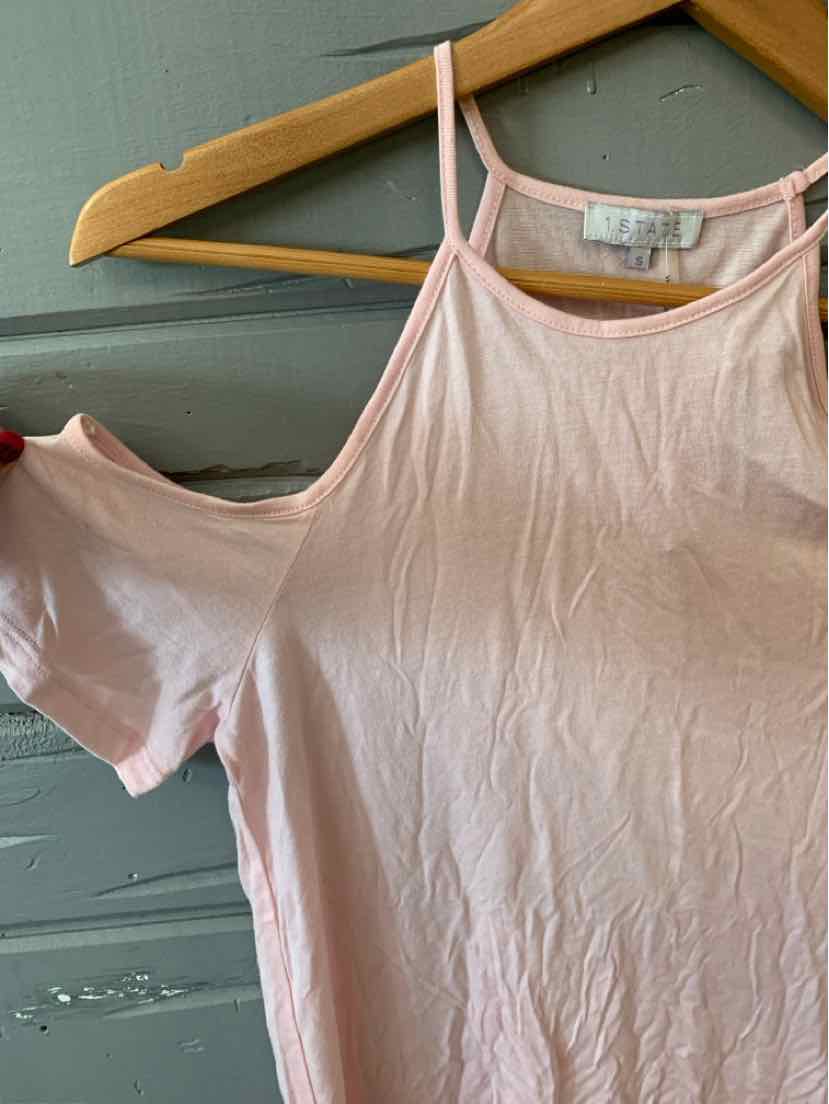 Light pink cold-shoulder short sleeve top with thin straps and soft fabric hanging on wooden hanger.
