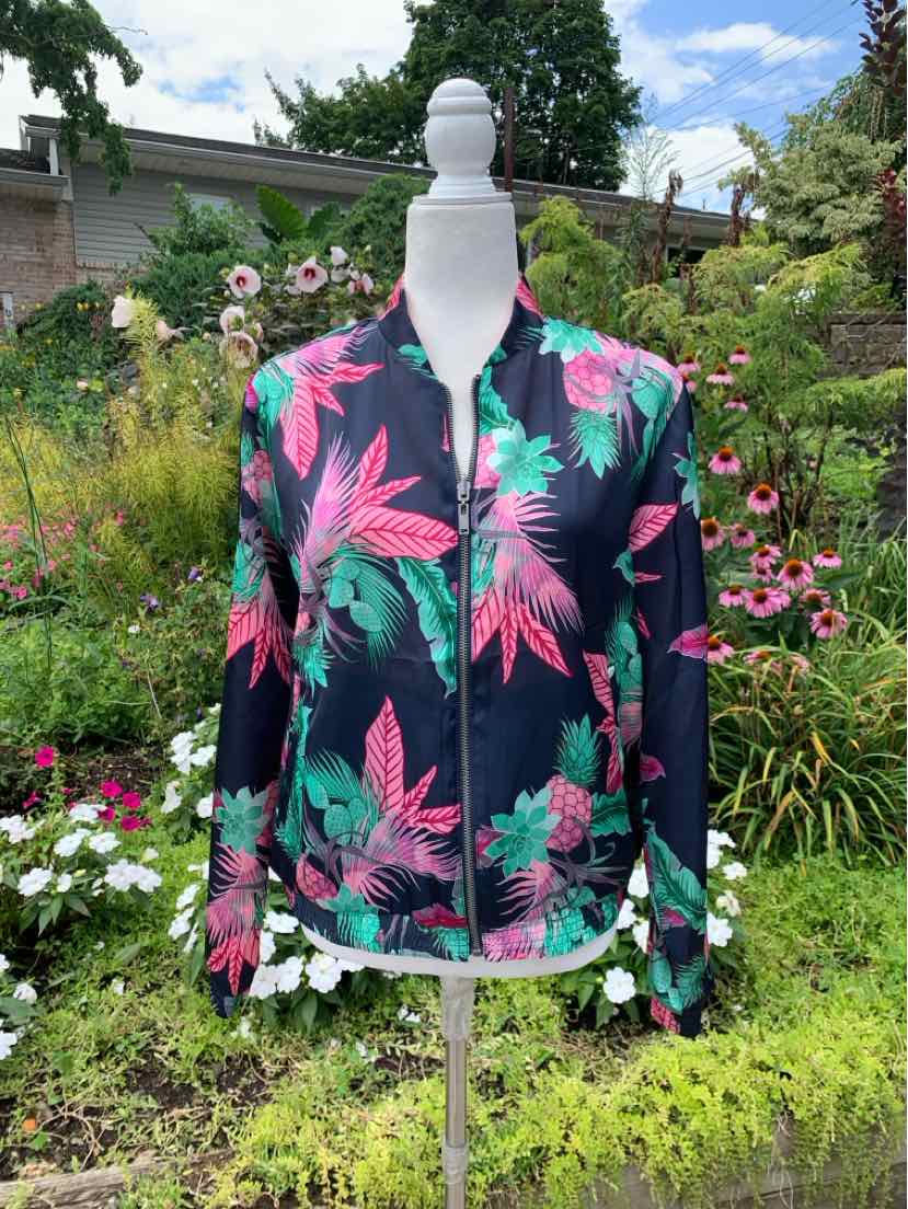 Navy zip-up jacket with vibrant pink and green tropical leaf print, long sleeves, and a fitted silhouette.
