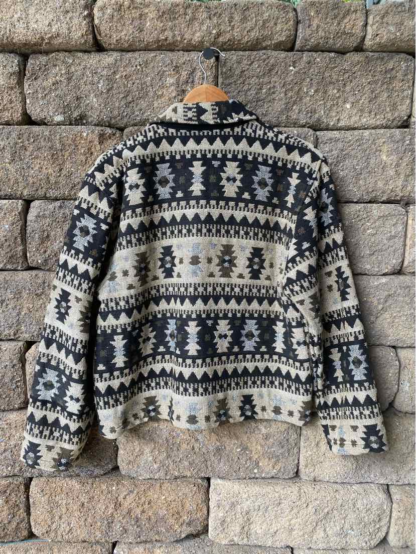 Black and white Aztec patterned knit sweater with long sleeves and a crew neck.