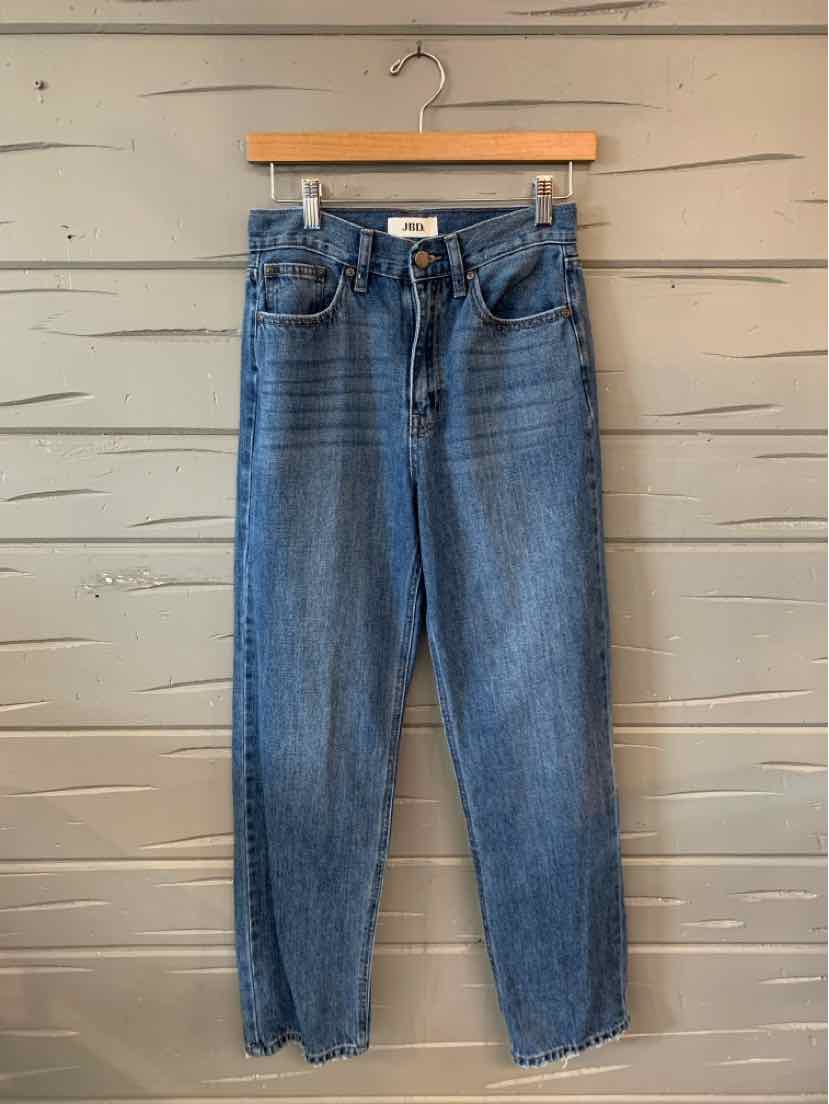 High-waist blue denim jeans with a straight-leg cut and frayed hem on wooden hanger.