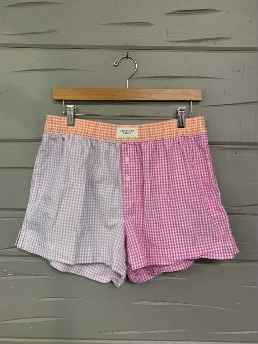 Two-tone gingham shorts in lavender and pink with an elastic waistband and a front button closure.