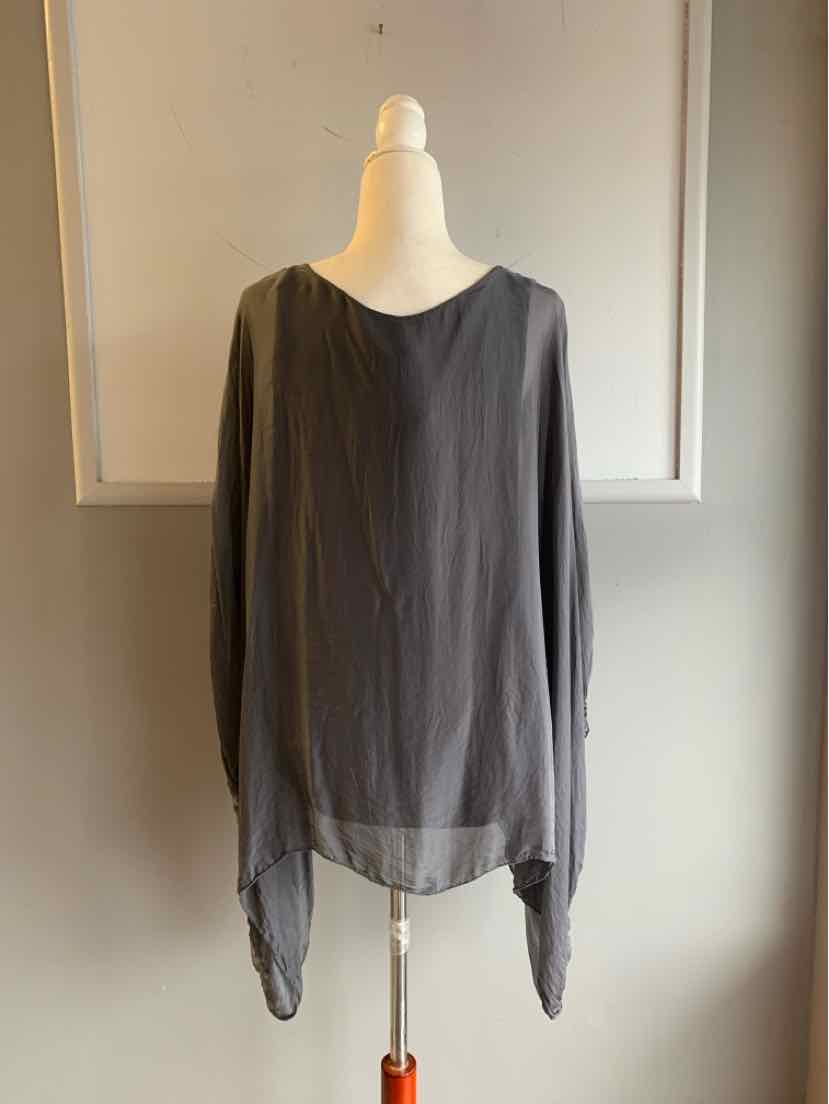 Lightweight grey-violet long-sleeve blouse with asymmetrical hem on mannequin.