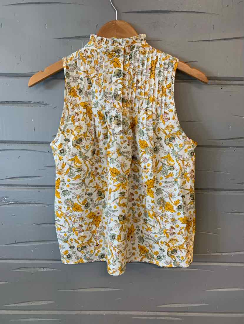 Sleeveless floral blouse in yellow and white with pleated back detail and button closure.