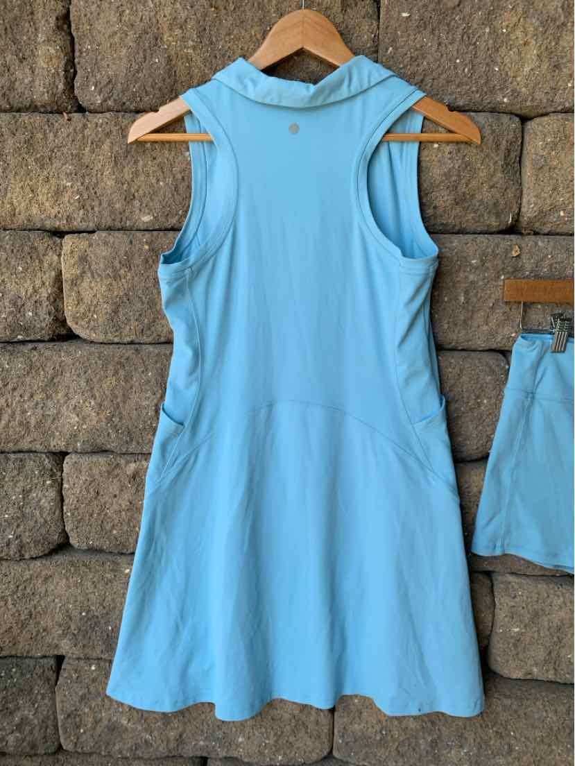 Light blue sleeveless athletic dress with racerback design and flared skirt, made from smooth lightweight fabric.