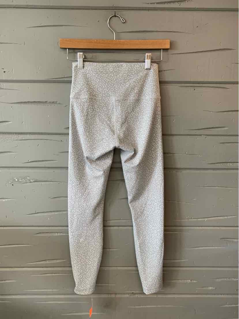 Light gray high-waist leggings with a subtle cheetah print and elastic waistband, size 8.