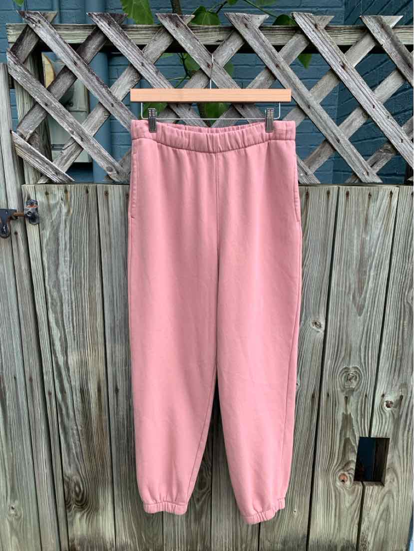 Soft pink fleece sweatpants with elastic waistband and cuffed ankles, medium size.