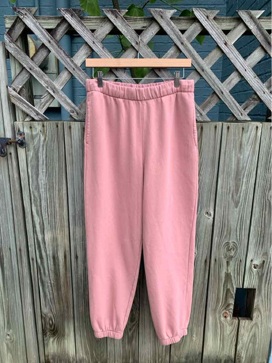 Soft pink fleece sweatpants with elastic waistband and cuffed ankles, medium size.