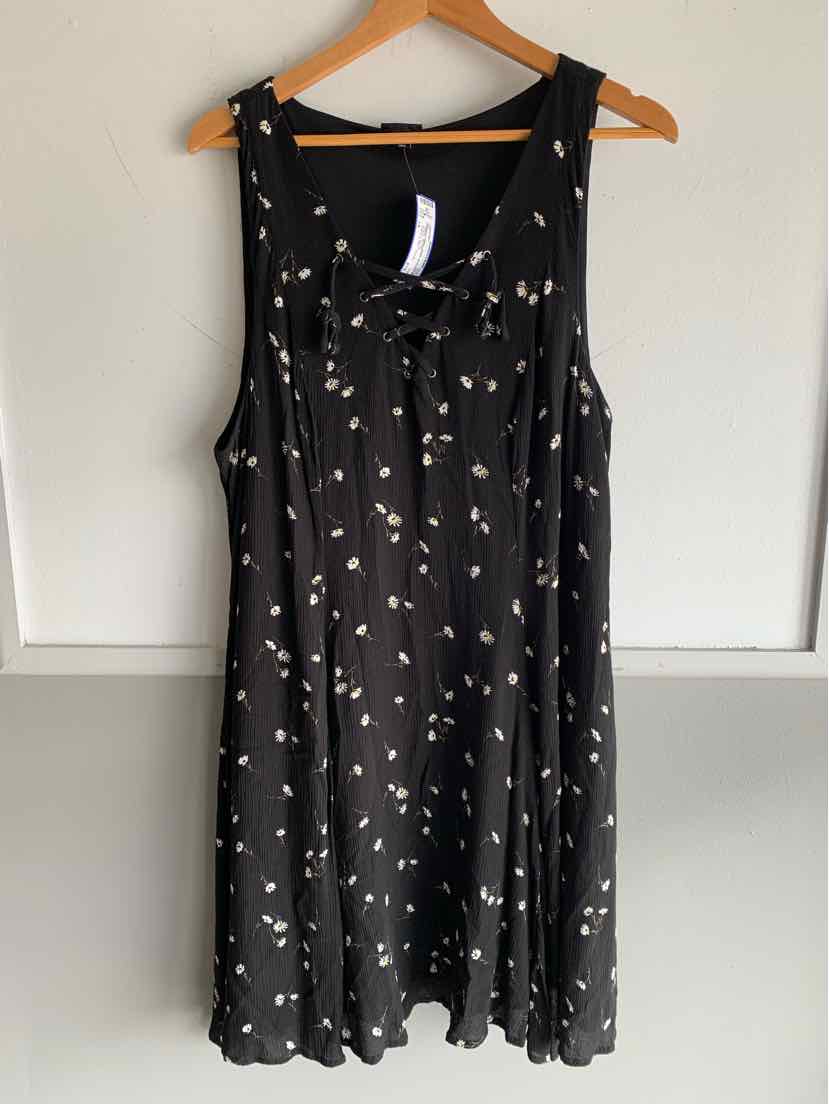 Black sleeveless dress with small white floral print and scoop neckline, size 1X.