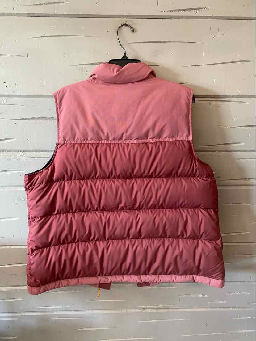 Pink quilted puffer vest with high collar and sleeveless design, size XL.
