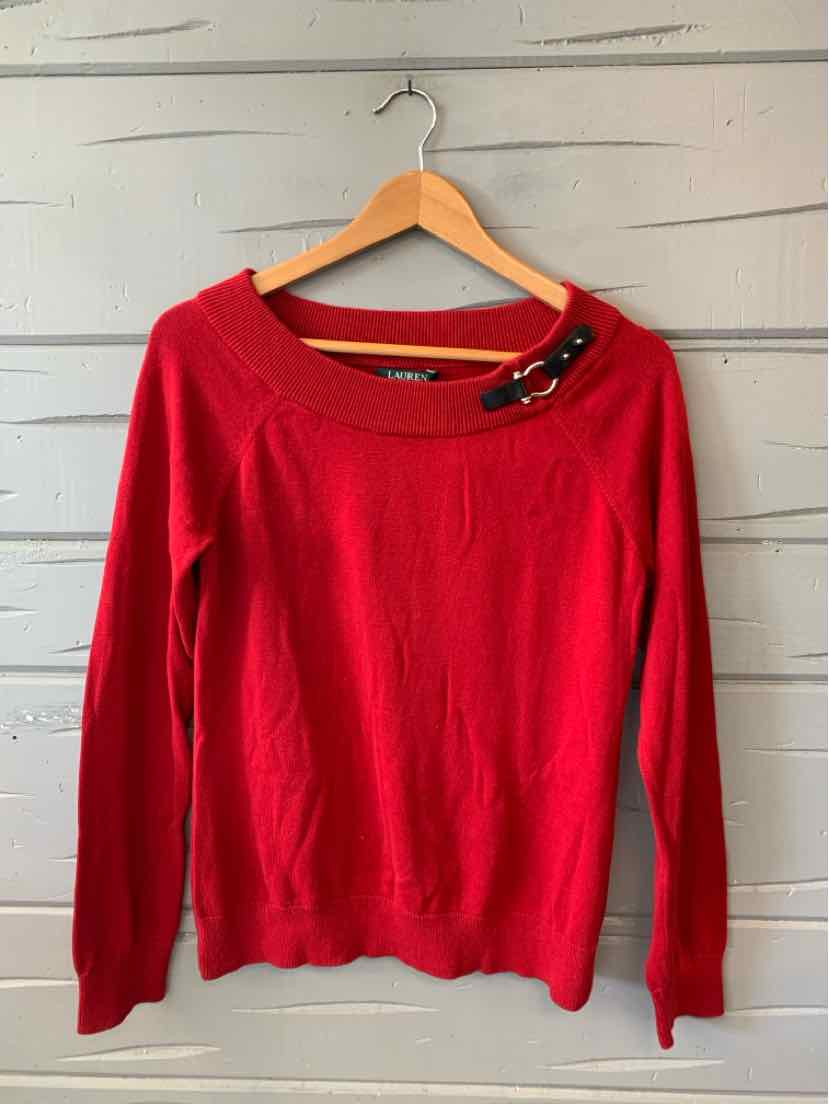 Red long-sleeve knit sweater with wide scoop neckline and decorative black buckle detail on shoulder.