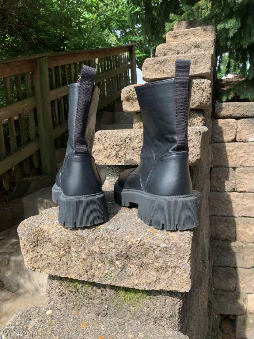 Black leather mid-calf boots with chunky lug soles and pull tabs at the back, size 7.5.