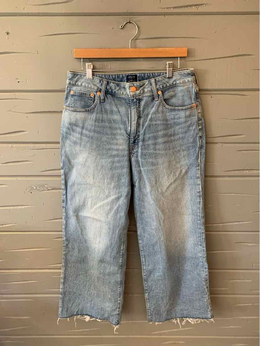 Light blue denim jeans with a faded wash, straight leg, frayed hems, and button closure at the waist.