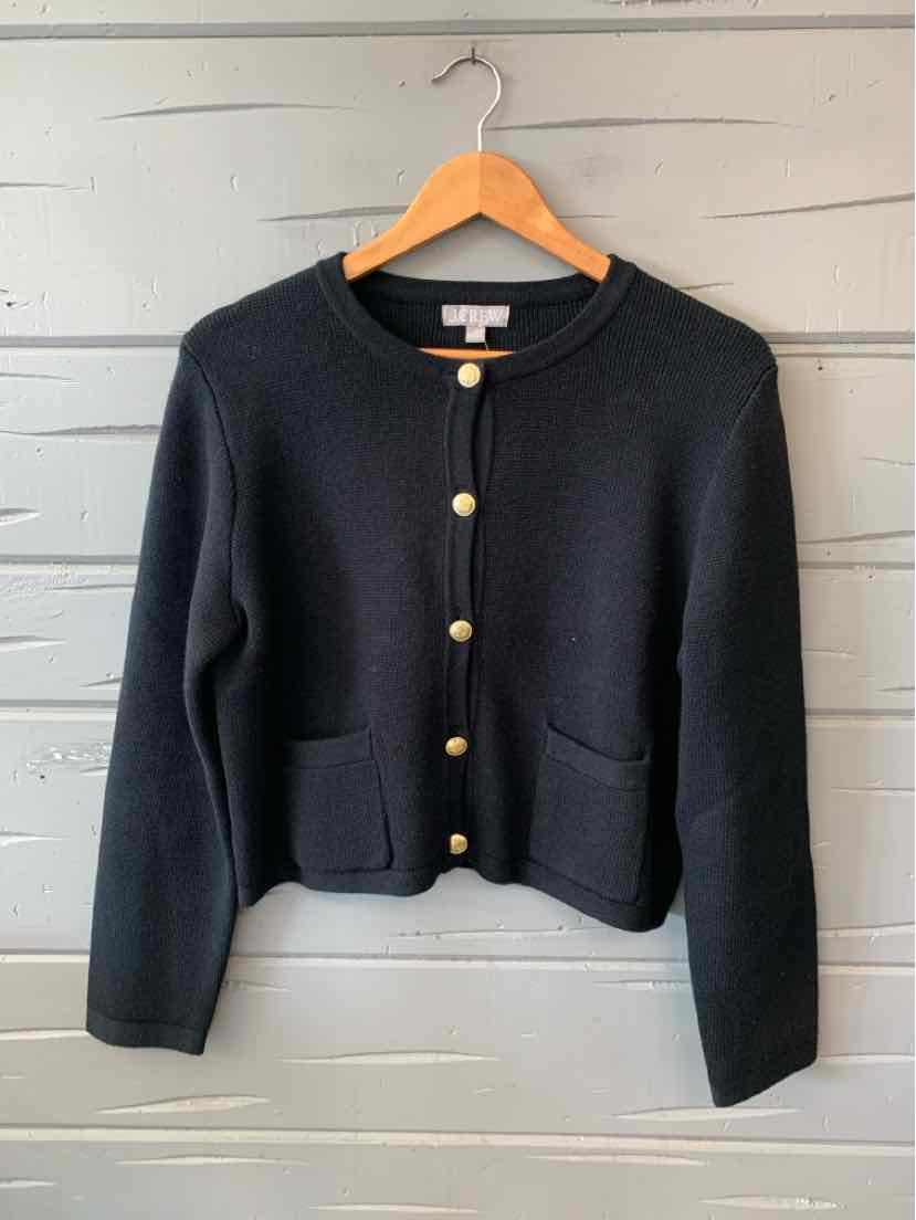 Black knit cardigan with gold buttons, crew neck, long sleeves, and two front pockets.