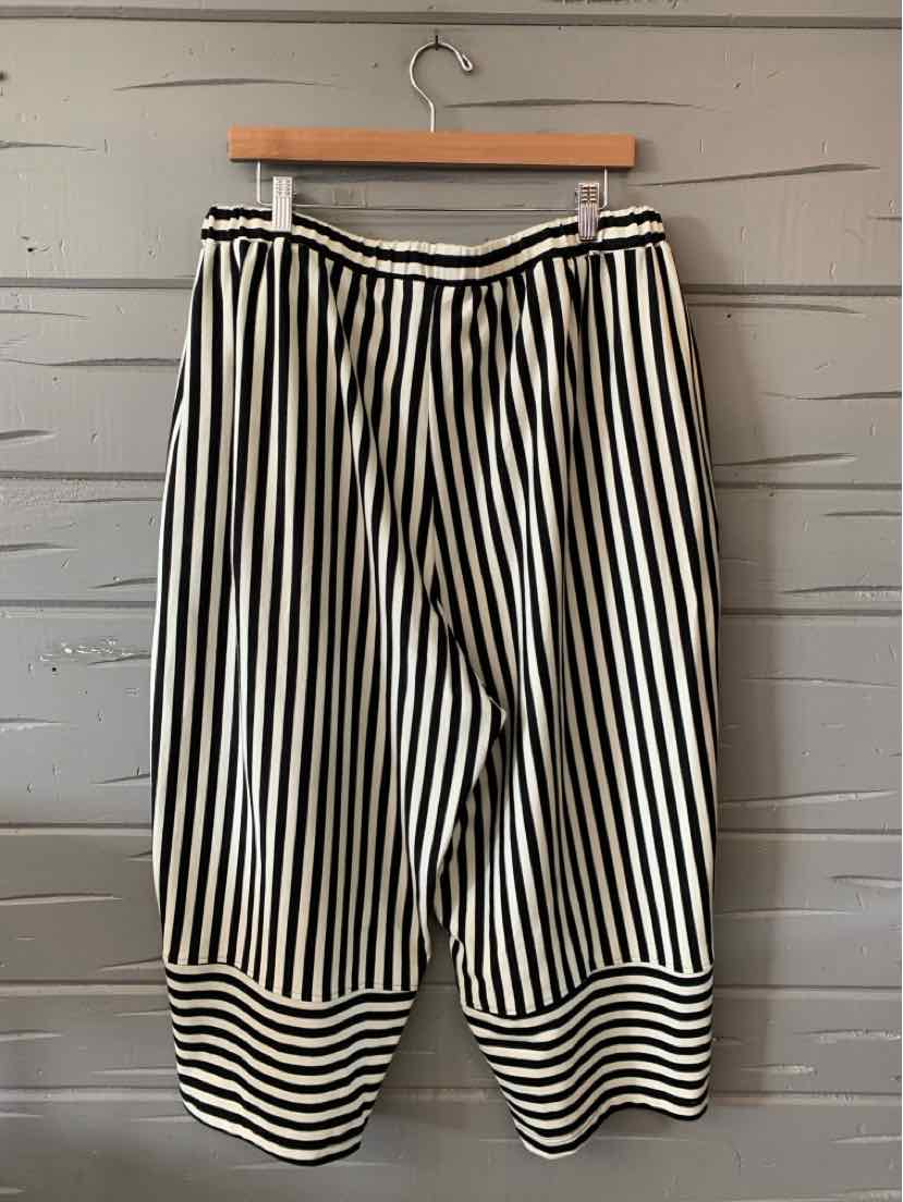 Black and white vertically striped wide-leg pants with a gathered waistband and striped cuffs.