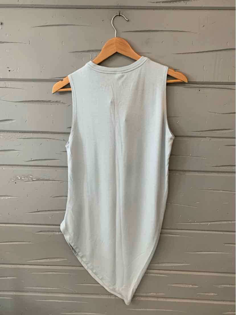 Light gray sleeveless top with an asymmetrical hem hanging on a wooden hanger.